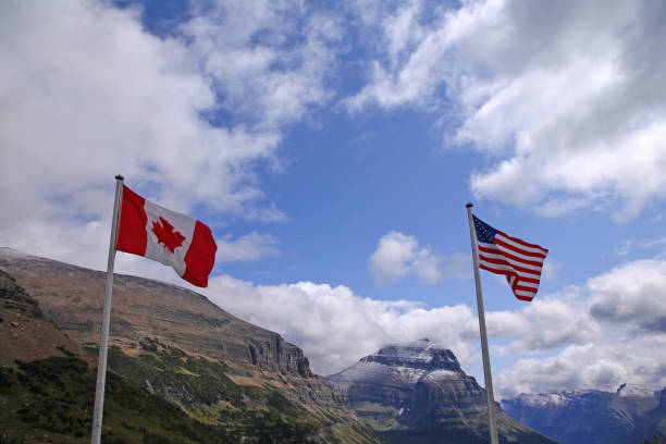 istock American and Canadian flags at Logan Pass 1223704166