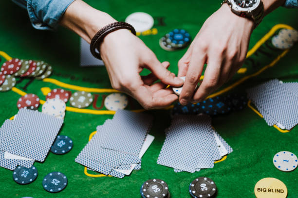 istock Croupier holds playing cards, game chips on the table. 1223705046