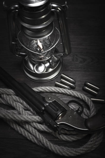 istock Old western cold blast lantern and revolver with cartridges 1223707461