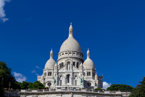 A stunning panoramic photo of the iconic Basilica of the Sacred Heart, majestically perched on Montmartre hill, capturing the essence of Paris, France