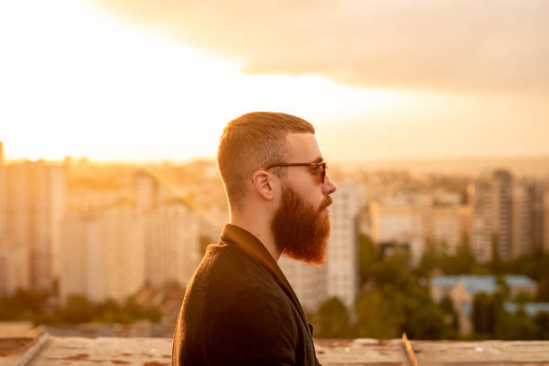 istock Stylish bearded male on rooftop in evening 1223714433