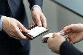 A close-up of a Japanese businessman exchanging business cards