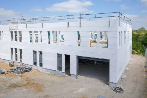 Photo of the outdoor shot of a building that is in the process of completion on a construction site