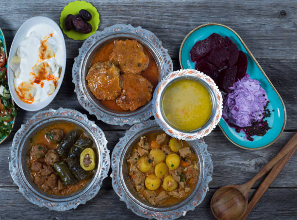 istock Eid Mubarak Traditional Ramadan Iftar dinner. Assorted tasty food in authentic rustic dishes on wooden table background. 1223732210