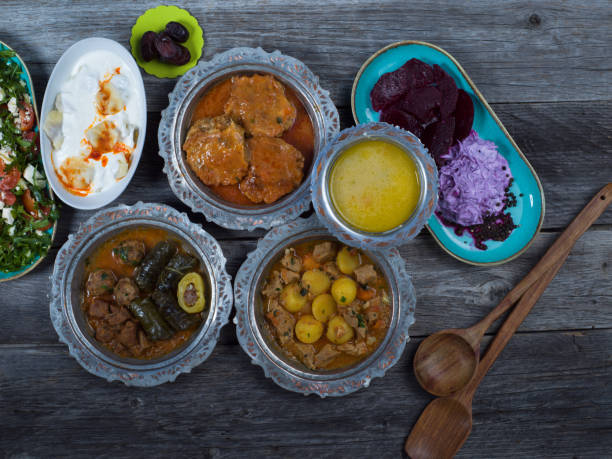 istock Eid Mubarak Traditional Ramadan Iftar dinner. Assorted tasty food in authentic rustic dishes on wooden table background. 1223732222