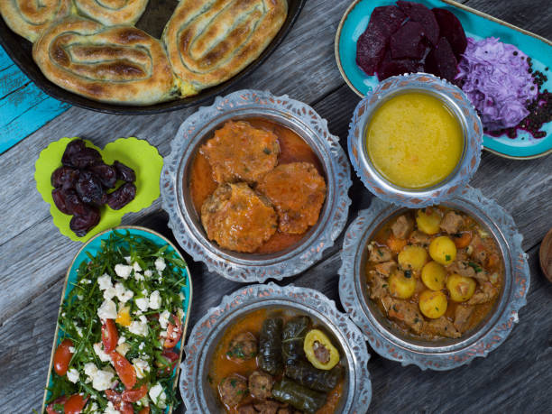 istock Eid Mubarak Traditional Ramadan Iftar dinner. Assorted tasty food in authentic rustic dishes on wooden table background. 1223732245