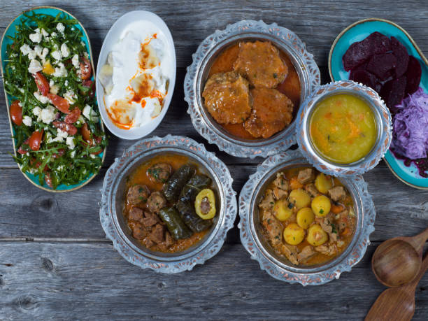 istock Eid Mubarak Traditional Ramadan Iftar dinner. Assorted tasty food in authentic rustic dishes on wooden table background. 1223732292