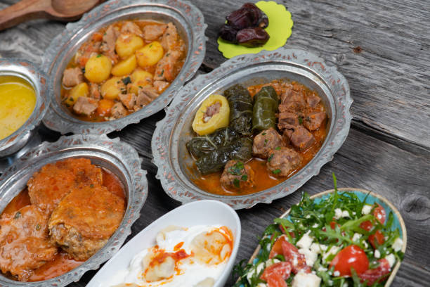 istock Eid Mubarak Traditional Ramadan Iftar dinner. Assorted tasty food in authentic rustic dishes on wooden table background. 1223732319