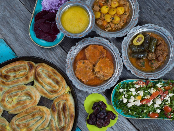 istock Eid Mubarak Traditional Ramadan Iftar dinner. Assorted tasty food in authentic rustic dishes on wooden table background. 1223732340