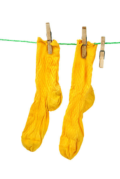 istock Pair of yellow socks hanging on the rope 122373487