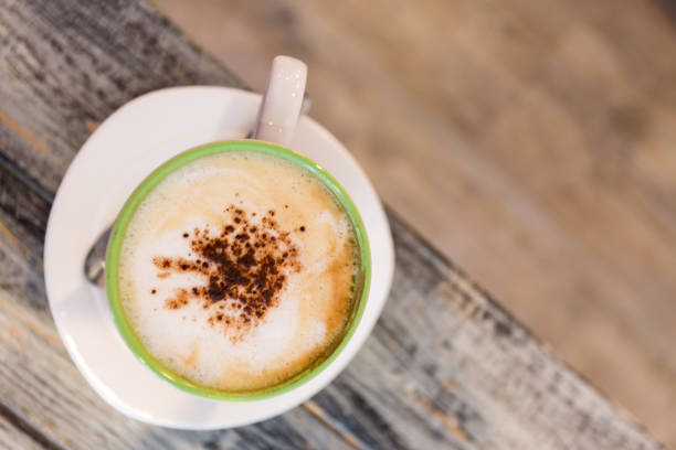 istock top view of cappuchino coffee on wood table background. 1223737326