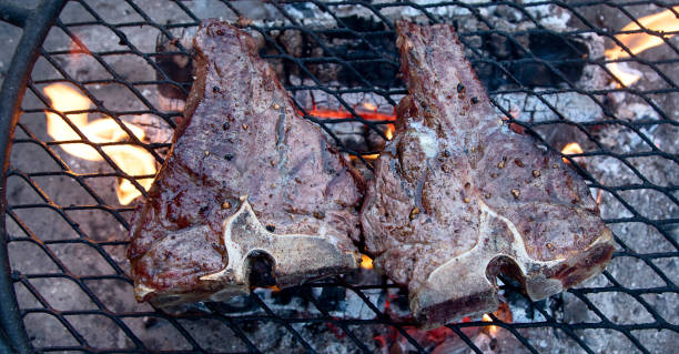 istock Grilling  beef steaks on flaming grill 1223739046