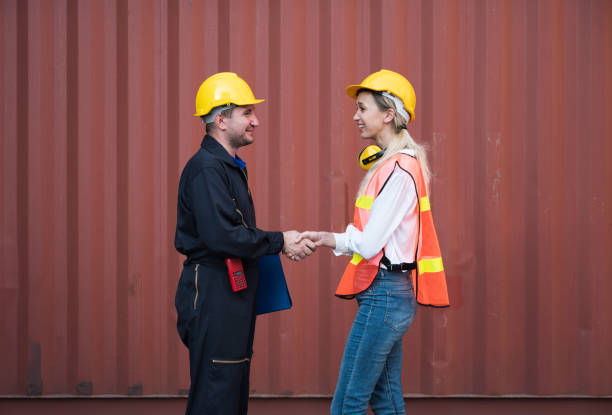 istock Happy dealing shaking hands two foreman man & woman worker working checking at Container cargo harbor to loading containers. Dock male and female staff business Logistics import export shipping concept. 1223739047