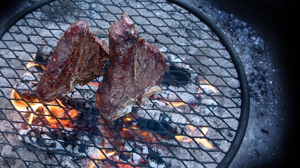 istock Grilling  beef steaks on flaming grill 1223739222