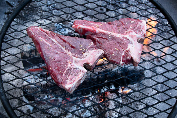 istock Grilling  beef steaks on flaming grill 1223739748