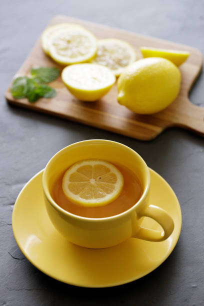 istock cup of tea with fresh yellow lemons on black background 1223740250