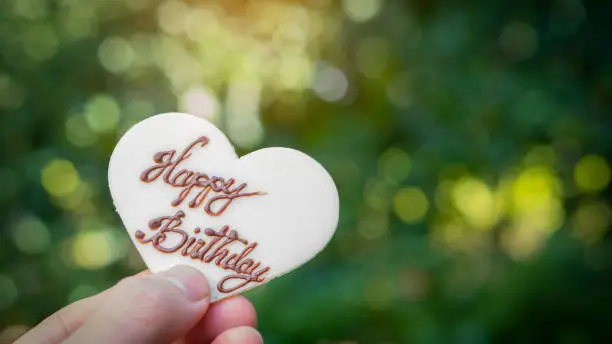 Heart shape made of sugar and HappyBirtday text with a beautiful blurred background