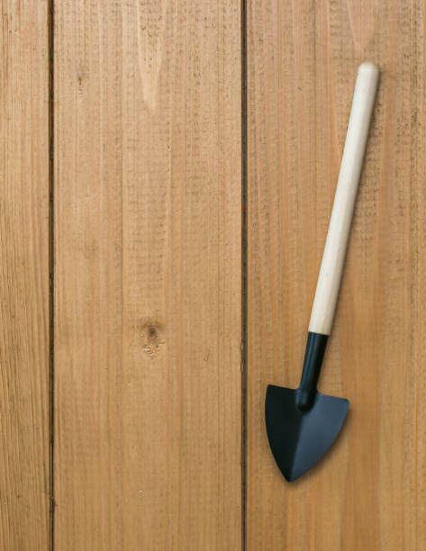 istock Shovel for digging soil on a wooden background. 1223743452