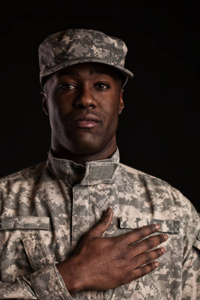 istock black soldier in uniform with hand on heart 1223744189
