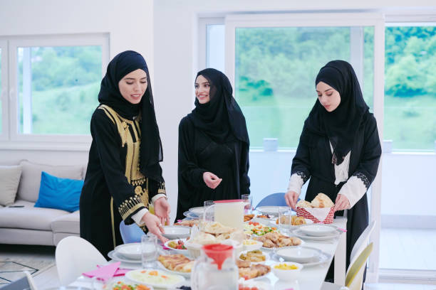 istock young muslim girls serving food on the table for iftar dinner 1223745285