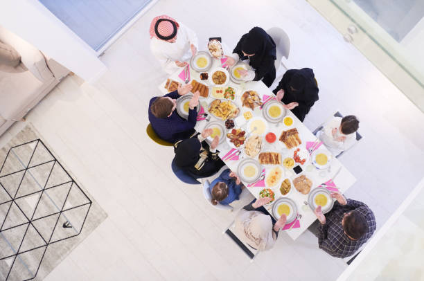 istock traditional muslim family praying before iftar dinner top view 1223745317
