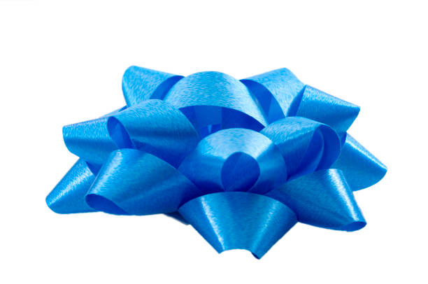 istock Shining anniversary gift and present decorating silky ornament concept blue sleek polished glossy bow isolated on white background clipping path cutout 1223747823