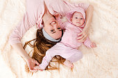 Smiling mother and baby girl in pink