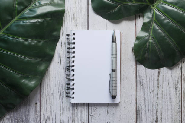 istock high angle view of notepad with pen on tiles background 1223751010