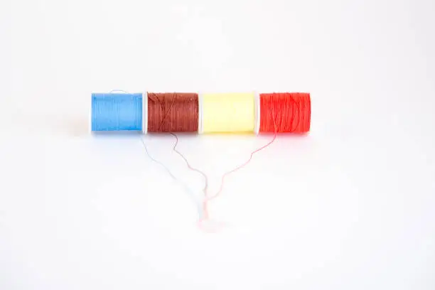 Colorful sewing thread reels isolated on a white background. Fashion and textile