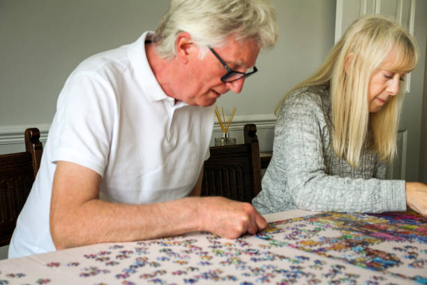 istock Senior couple doing jigsaw puzzle together at home 1223754806
