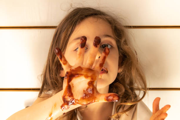 istock Little girl with chocolate stained hands 1223756127
