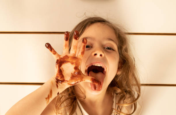 istock Little girl with chocolate stained hands 1223756137