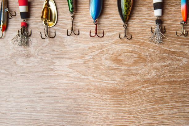 istock Fishing lures on a wooden background close up 1223756981