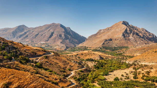 Crete Island Mountain Range Panorama under clear blue Skyscape in warm late afternoon light. Central Crete Mountain Range, Crete Island, Kriti, Greece, Mediterranean Countries, Europe