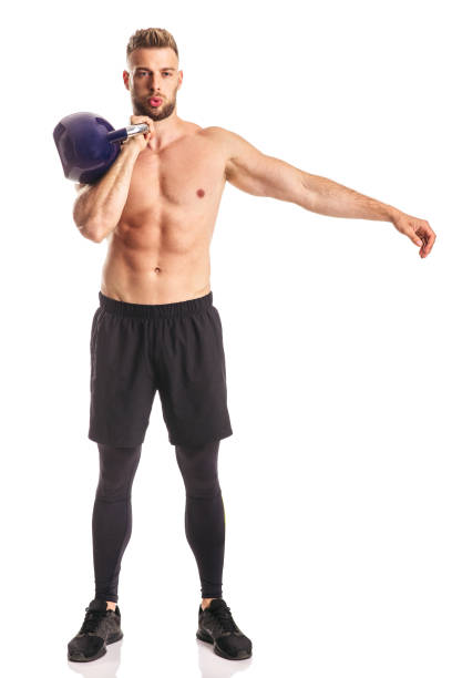 istock Young muscular male lifting weight in studio 1223758030