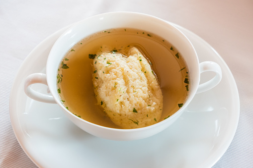 Semolina Dumpling Soup, Beef Broth with Parsley in a White Bouillon Cup, a Specialty of Austrian and Viennese Cuisine