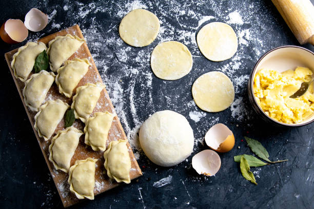 istock Raw dumpling. Preparation dumplings with potatoes. On dark rustic background. Top views, close-up 1223760533