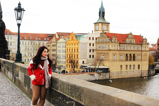 asian woman traveler enjoy the autumn season in Prague old town