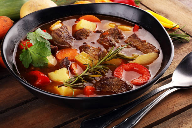 istock Meat stew with vegetables. Beef stew with potatoes, carrots and fresh herbs on table. 1223762029