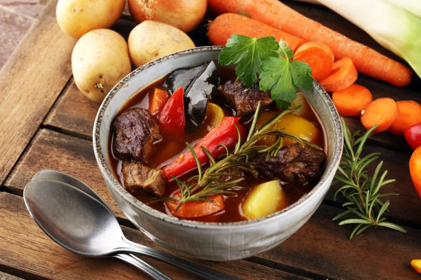 istock Meat stew with vegetables. Beef stew with potatoes, carrots and fresh herbs on table. 1223762081