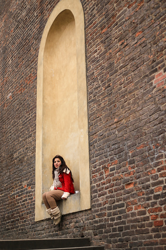 asian woman traveler  sitting on urban wall