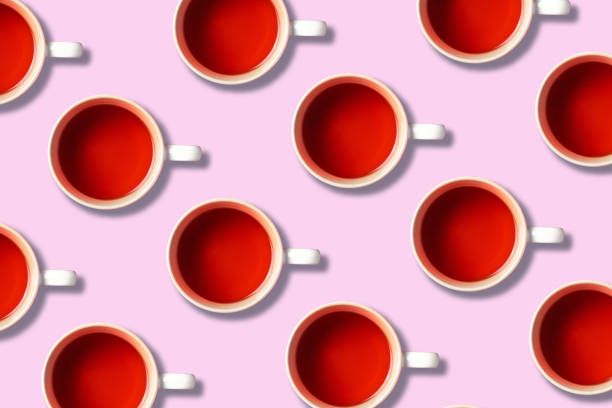 istock Pattern of tea cups on pink background. Top view. Copy space. Creative design for packaging. Autumn or winter season concept 1223762816