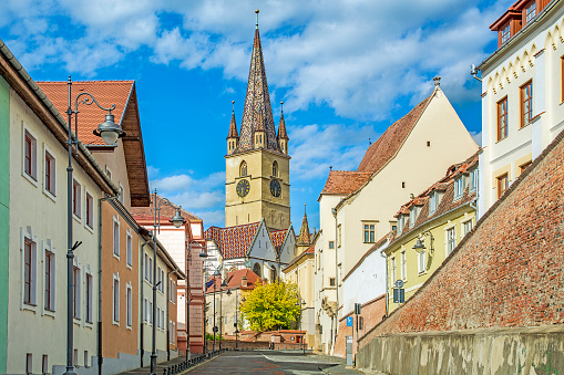 Sibiu, Transylvania, Romania, street in old town and tower gothic lutheran cathedral from XIVth century
