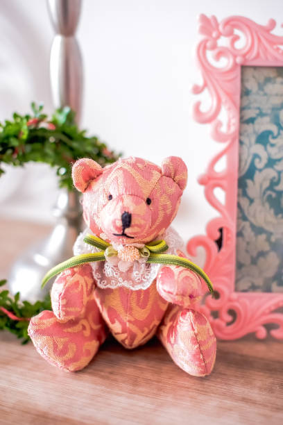 istock pink vintage bear with selective focus on the table 1223765091