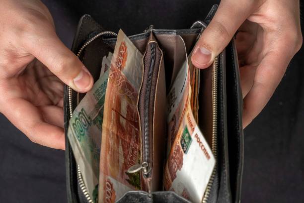 istock man with a black wallet full of russian money 1223771102