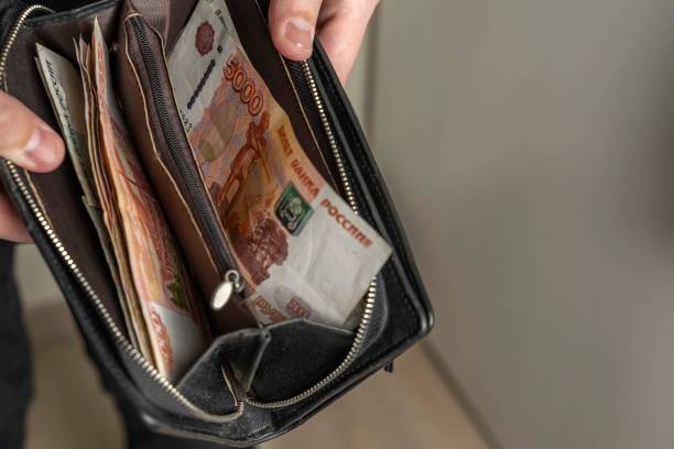istock man with a black wallet full of russian money 1223771103