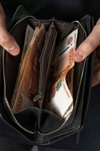 istock man with a black wallet full of russian money 1223771104