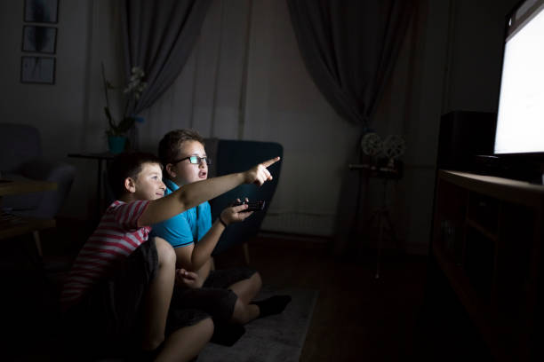 istock Boys watching a movie at home at night 1223771592