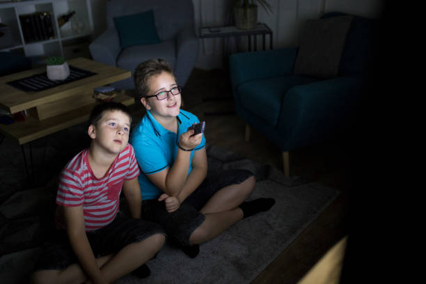 istock Boys watching a movie at home at night 1223771704