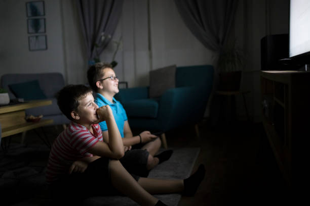 istock Boys watching a movie at home at night 1223771823